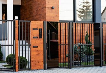 Modern house entrance with wooden gate.