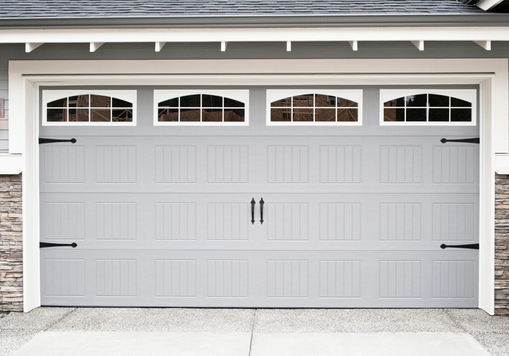 Gray double garage door with windows.